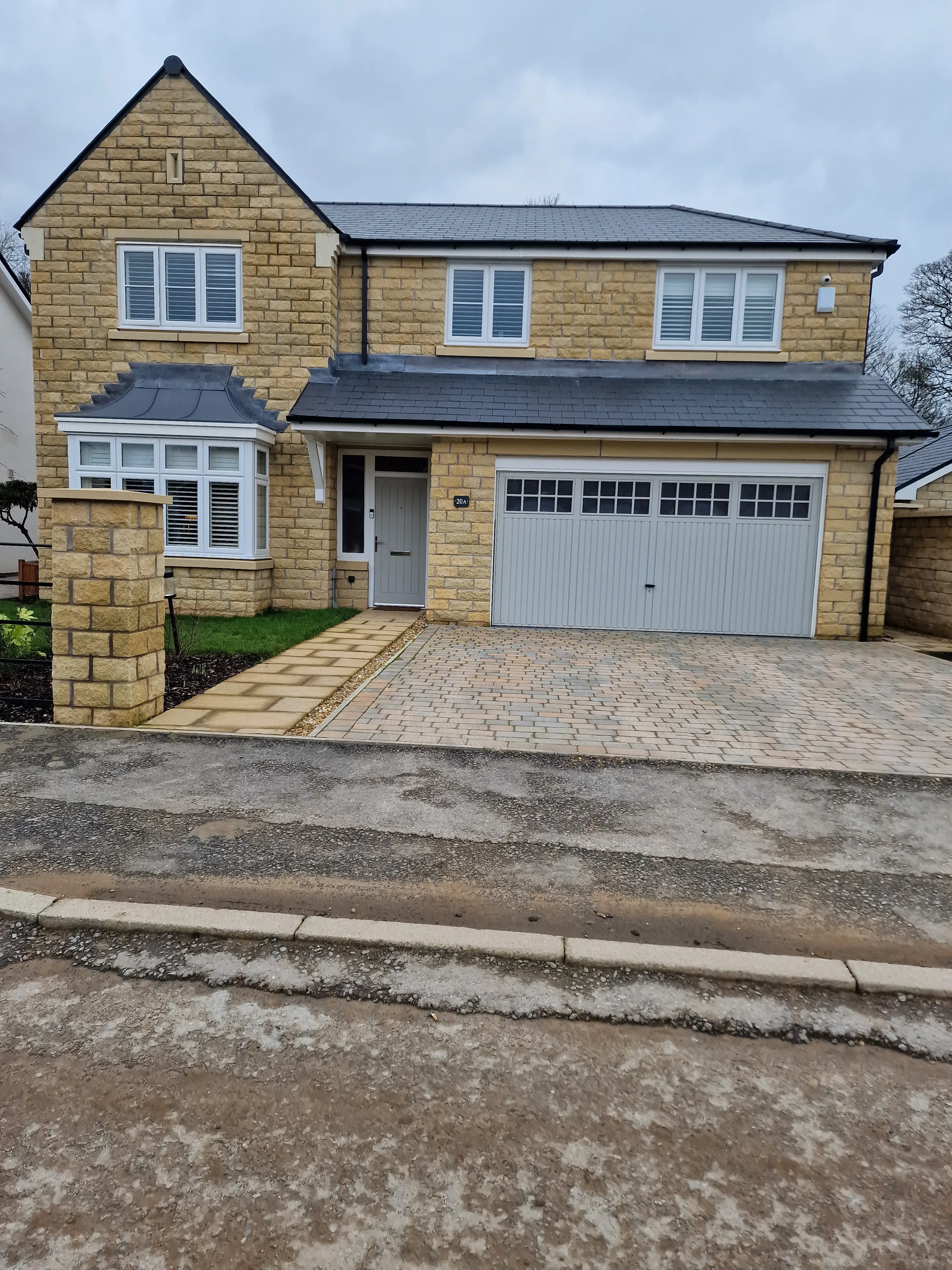 A large brick house with a driveway leading to it.